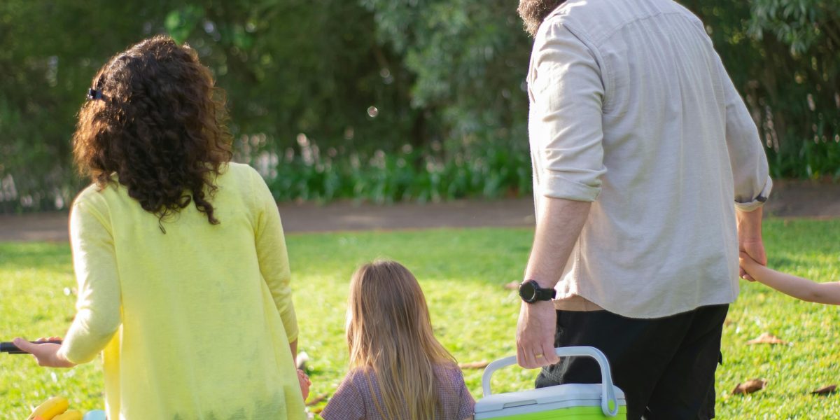 A family enjoying outdoor activities in a park, representing the positive outcome of choosing the right neighborhood.