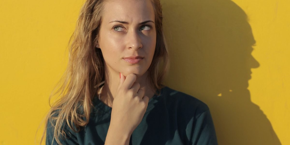 A person thoughtfully considers various factors when searching for a new home.