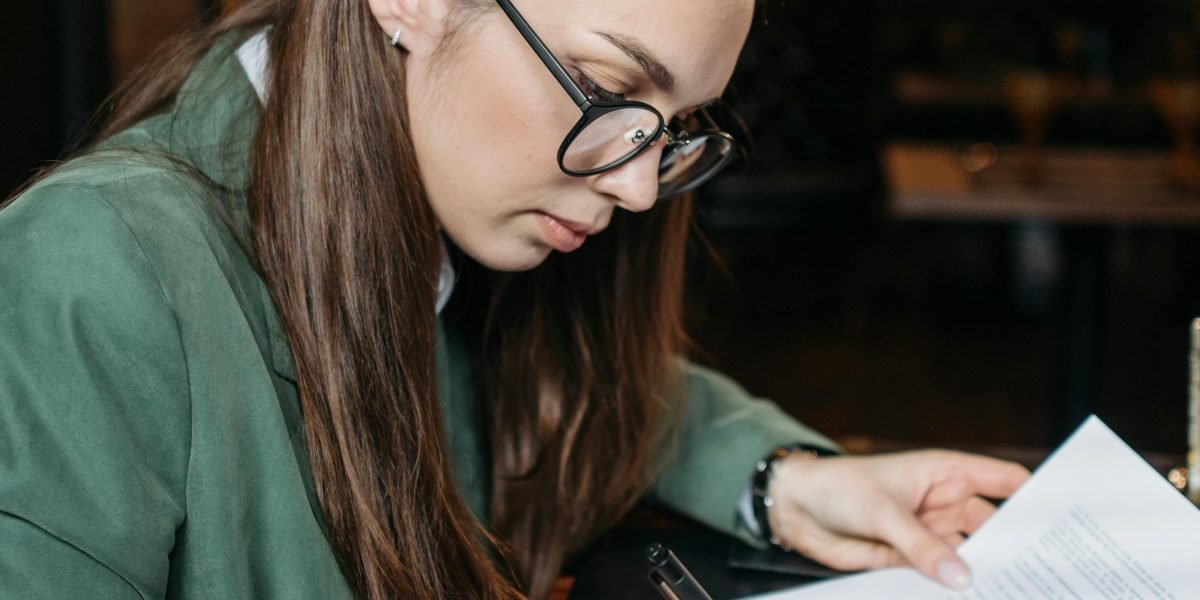 A person confidently reviews and signs important rental documents, ensuring all terms are understood.