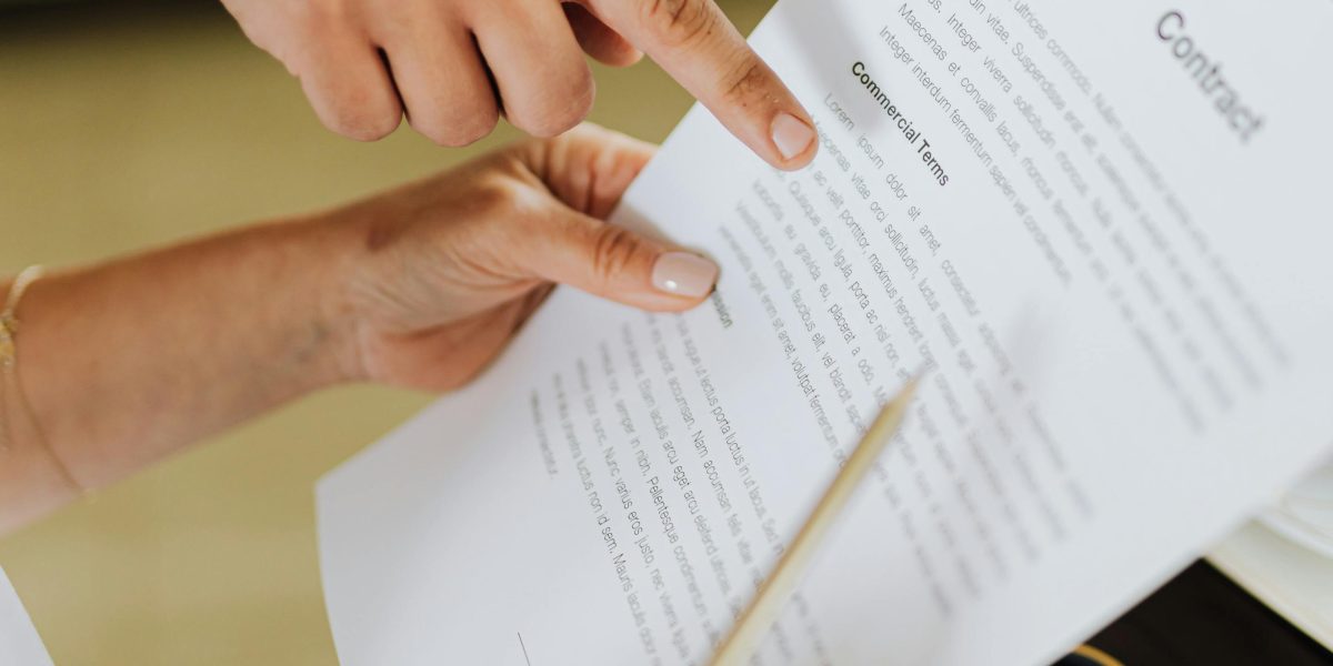 People carefully reviewing a rental contract together, emphasizing the importance of understanding terms and conditions.