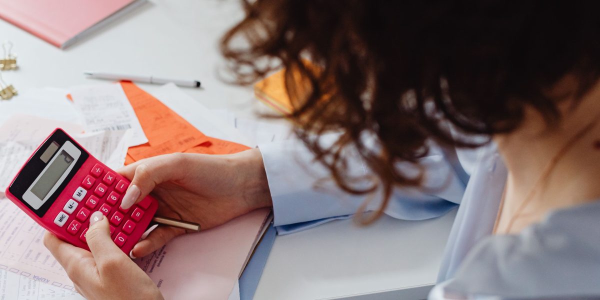 A professional analyzing detailed financial reports and data.