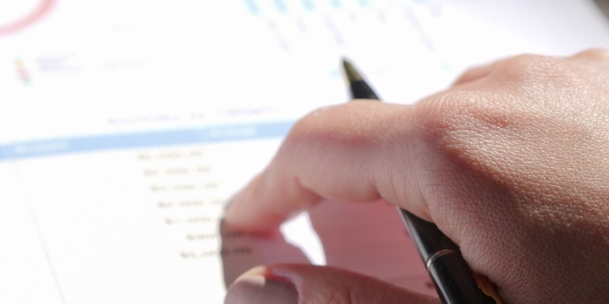 A person meticulously reviews rental prices and personal budget to make informed decisions.