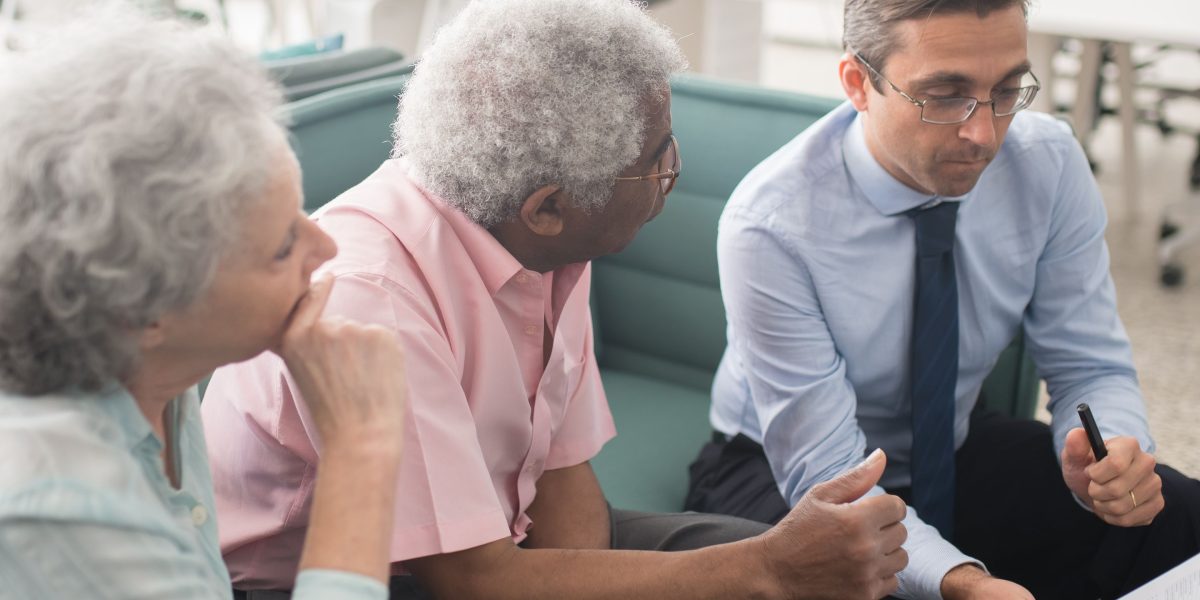 Professionals engaged in a detailed discussion about financial planning and investment strategies.