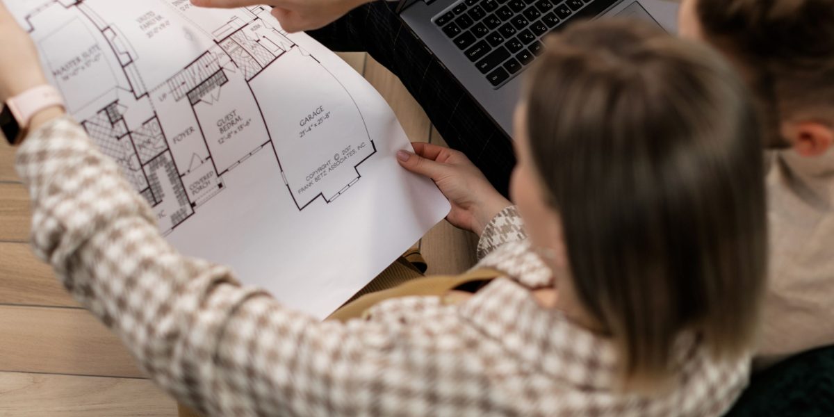 An individual contemplating real estate investment, possibly looking at a map or property details.