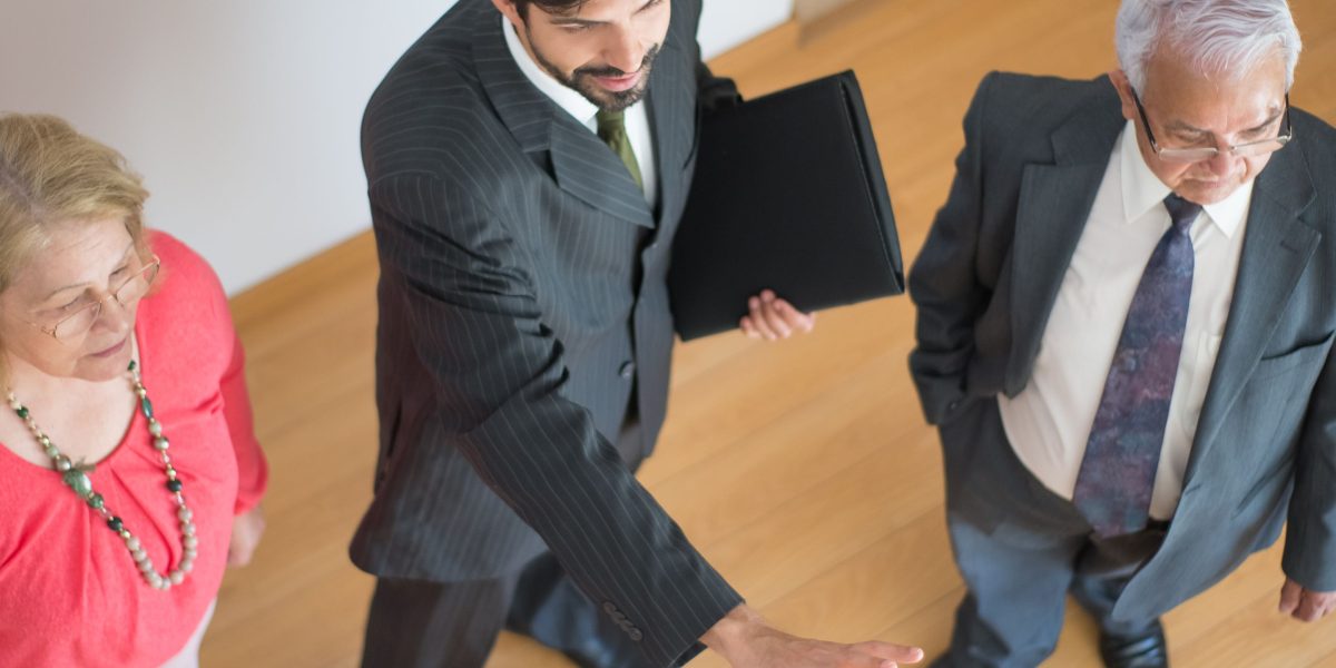 Individuals reviewing documents and discussing investment strategies in a modern office setting.