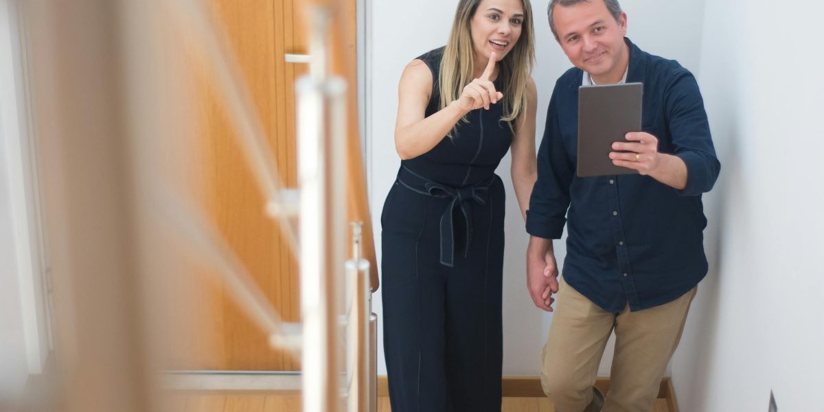 A prospective tenant exploring the interior of a bright, modern apartment during a viewing.