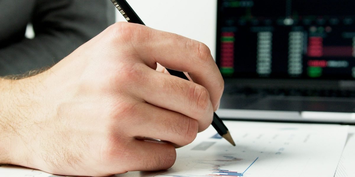 An investor thoughtfully reviewing market trends and data to identify prime opportunities.