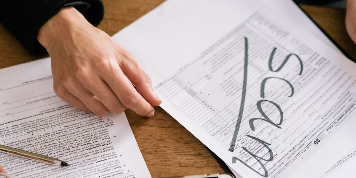 A person carefully reviewing financial documents, representing the crucial step of assessing personal financial health.