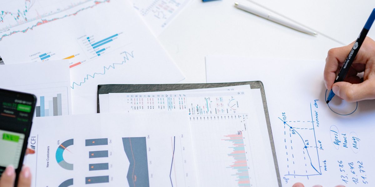 A group of professionals collaborating to analyze market trends and develop a diversified investment portfolio strategy.
