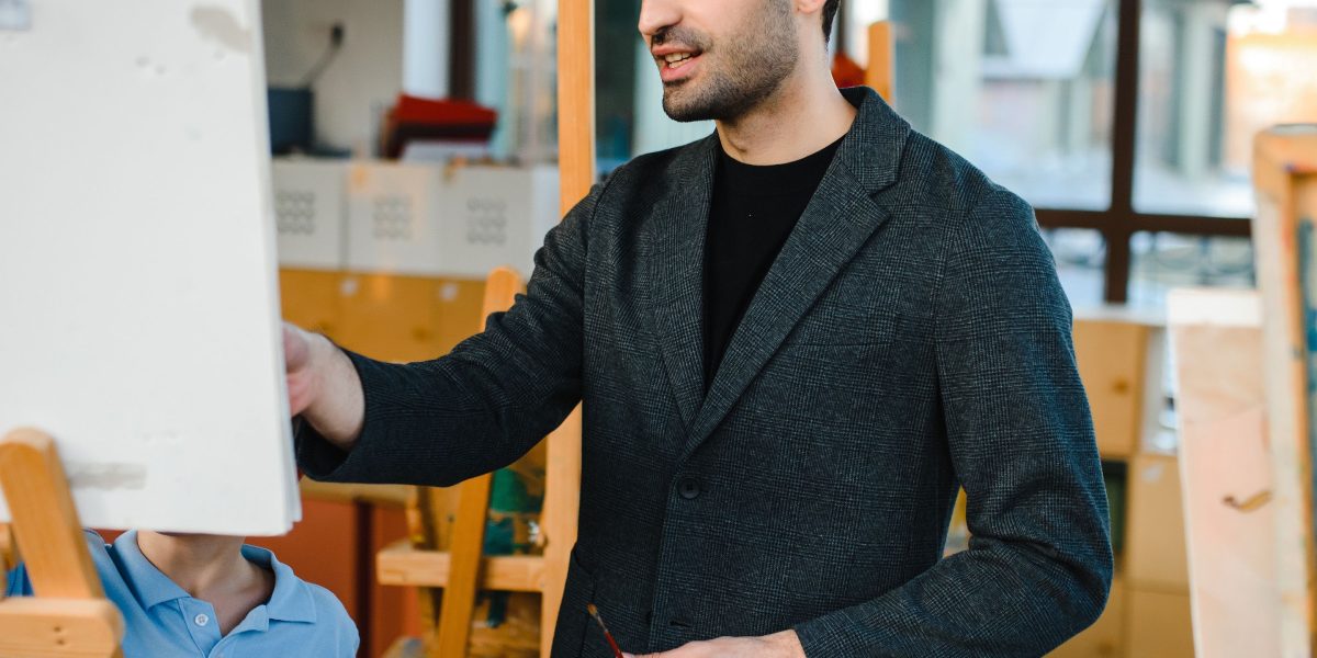 An experienced financial professional providing guidance to a mentee in a modern office setting.