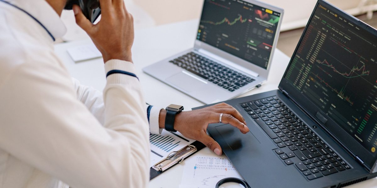 An investor carefully analyzes market data and projections to assess potential returns.