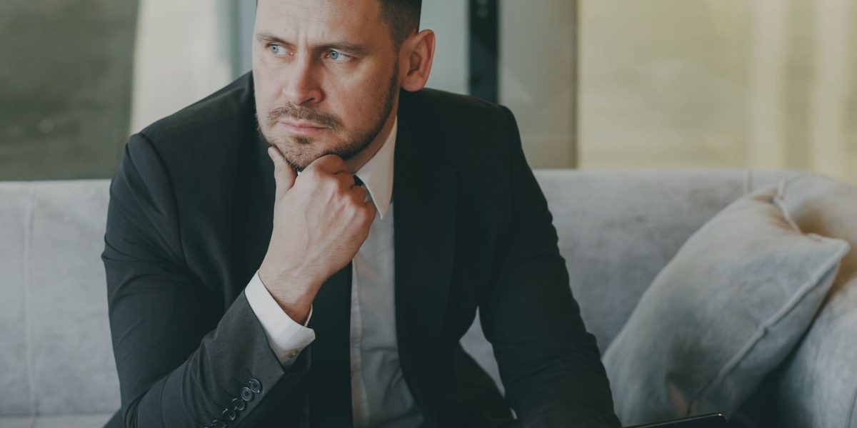 An individual thoughtfully considering various factors influencing their career path and financial growth.