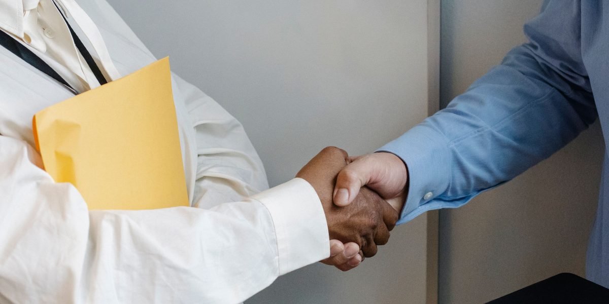 Two professionals shaking hands, symbolizing trust and a successful engagement with a reliable financial advisor.