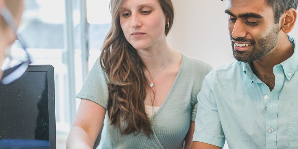 A couple engaged in a serious discussion about their future financial plans, symbolizing the importance of professional advice.