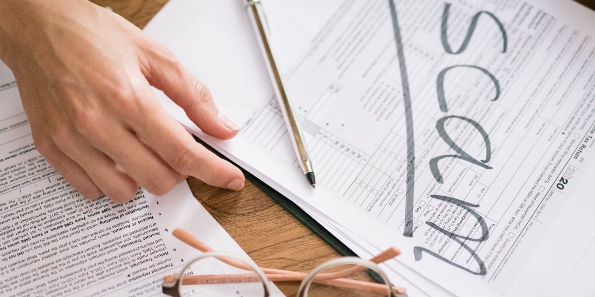 A person carefully reviewing important official documents, representing the process of securing visas or residency.