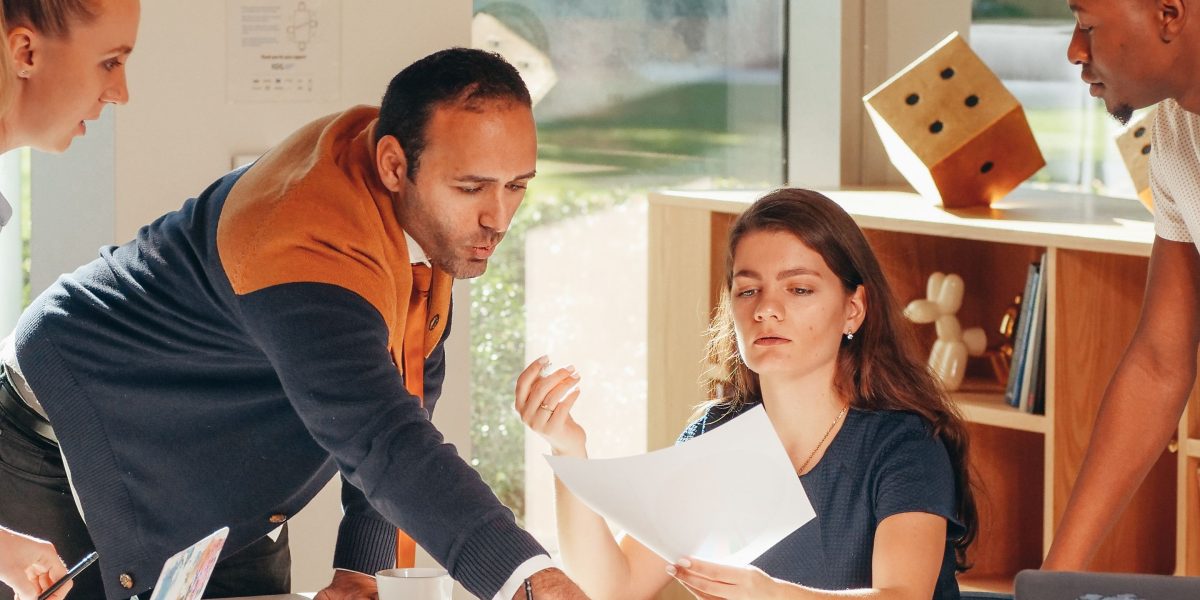 A team collaborating to adapt to new market trends, reflecting the digital transformation in Dubai's financial sector.