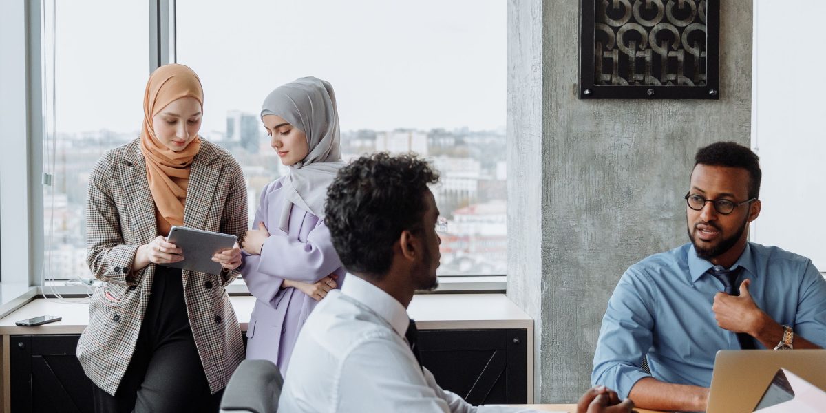 Professionals engaged in a discussion or presentation in a contemporary office setting, representing Dubai's business environment.