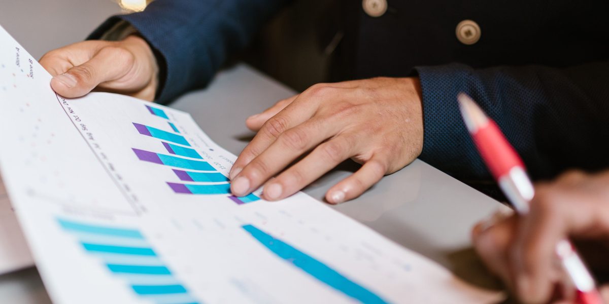 An investor and advisor discussing strategies for expanding a property rental portfolio and future investments.