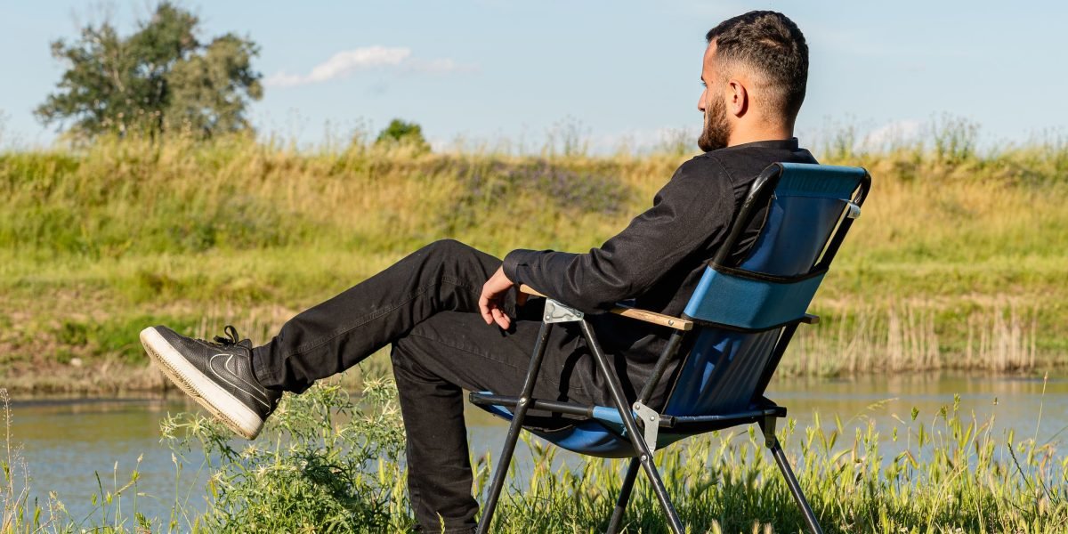 A person enjoying a serene moment with a panoramic view from a high-end property, embodying the luxury lifestyle District One offers.
